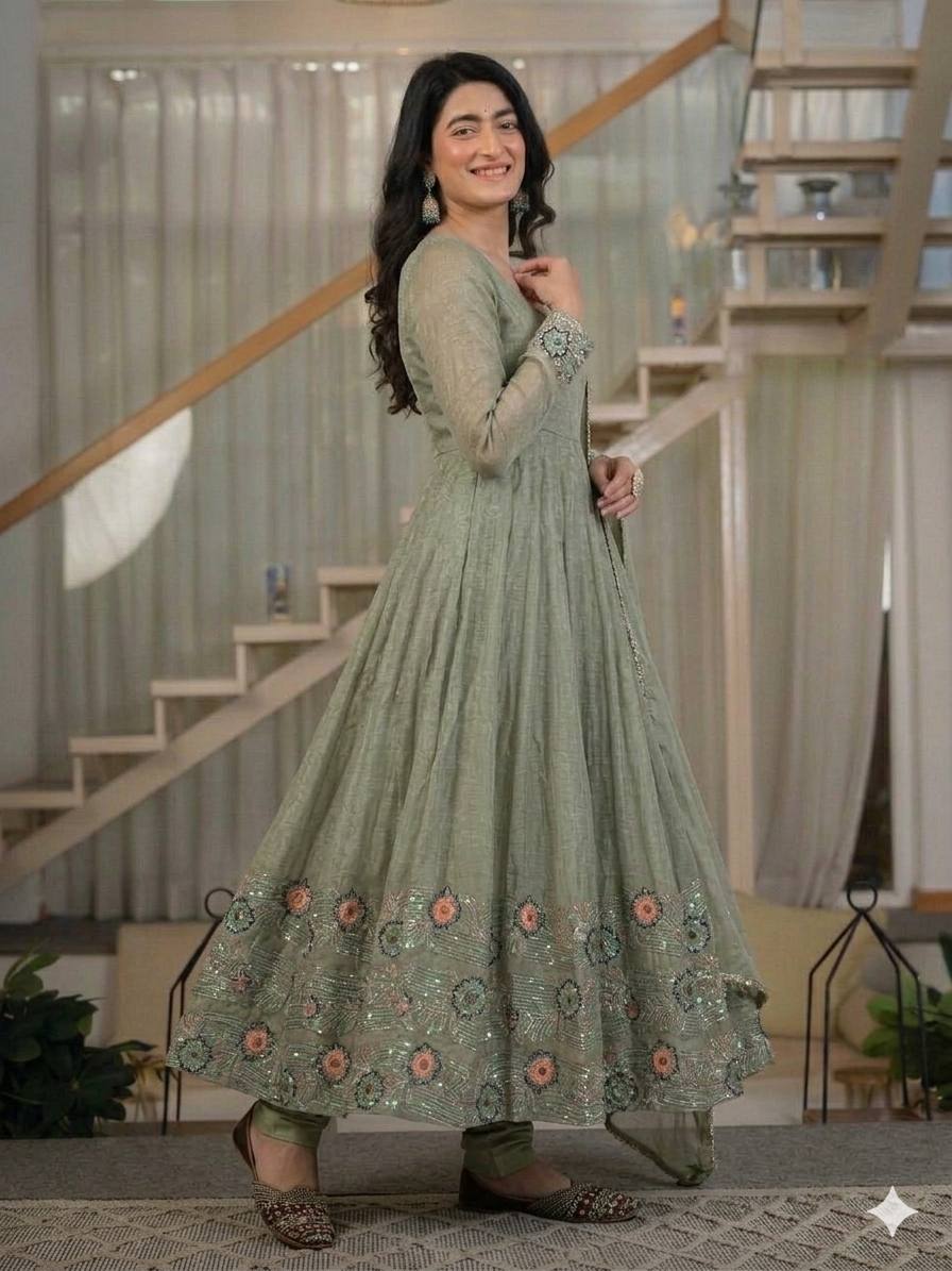 Ethereal Mehendi Green Flared Anarkali Suit Set Adorned with Luminous Sequined Floral Motifs, Embroidered Cuffs, and an Ornate Heritage Hem